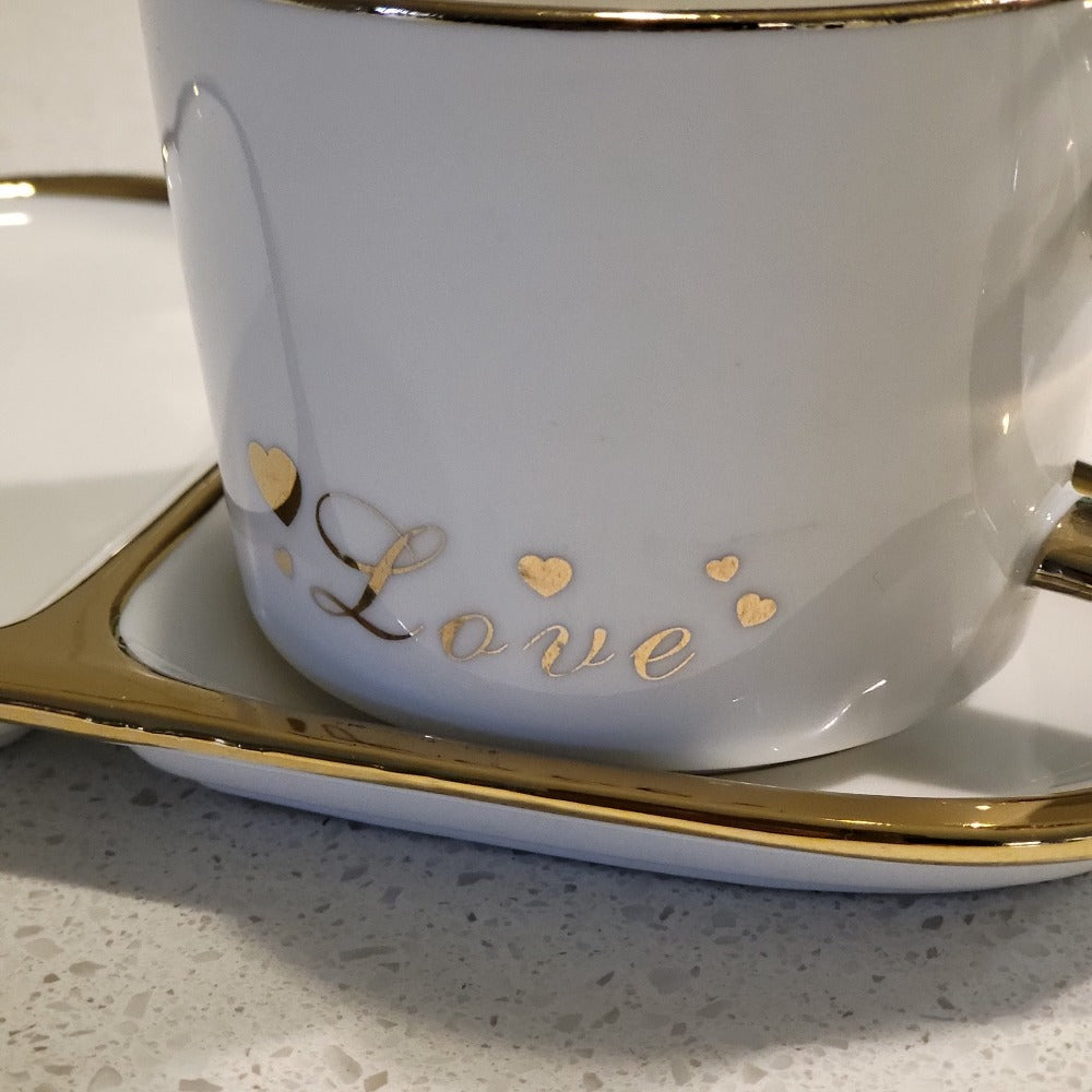 Golden Trim Modern Love Style Tea Cup, a Saucer and Gold Spoon in White