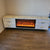 White MDF Material with Bronze Stainless Steel Frame and White Grey Marble TV Cabinet with a Fireplace Reflector and a Remote