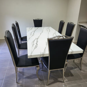 Classy Marble Dining Table With Classy and Classic Black Leather Style Dining Room Chairs in Silver Stainless Steel Frame